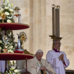 
              Pope Francis sits by the relics of ten new saints on the altar in St. Peter's Square at The Vatican, Sunday, May 15, 2022, where he celebrated their canonization mass. Francis created ten new saints on Sunday, rallying from knee pain that has forced him to use a wheelchair to preside over the first canonization ceremony at the Vatican in over two years. (AP Photo/Gregorio Borgia)
            