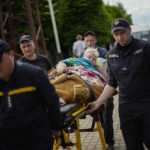 
              A patient is carried on a stretcher to board a medical evacuation train run by MSF (Doctors Without Borders) at the train station in Pokrovsk, eastern Ukraine, Sunday, May 29, 2022. The train is specially equipped and staffed with medical personnel, and ferries patients from overwhelmed hospitals near the front line, to medical facilities in western Ukraine, far from the fighting. (AP Photo/Francisco Seco)
            