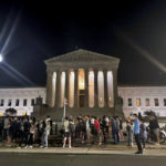 
              A crowd of people gather outside the Supreme Court, Monday night, May 2, 2022 in Washington. A draft opinion circulated among Supreme Court justices suggests that earlier this year a majority of them had thrown support behind overturning the 1973 case Roe v. Wade that legalized abortion nationwide, according to a report published Monday night in Politico. It’s unclear if the draft represents the court’s final word on the matter.  The Associated Press could not immediately confirm the authenticity of the draft Politico posted, which if verified marks a shocking revelation of the high court’s secretive deliberation process, particularly before a case is formally decided. (AP Photo/Anna Johnson)
            