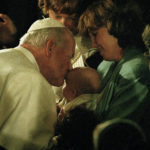 
              FILE - In this Sept. 15, 1987, photo taken by Associated Press photographer Leonard Ignelzi, Pope John Paul II kisses the forehead of an infant during a short prayer service at the Cathedral of Vibiana in Los Angeles. Ignelzi, whose knack for being in the right place at the right time produced breathtaking images of Hall of Fame sports figures, life along the U.S.-Mexico border, devastating wildfires and numerous other major news events over nearly four decades as a photographer for The Associated Press in San Diego, has died Friday, April 29, 2022. He was 74. (AP Photo/Lenny Ignelzi, File)
            
