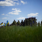 
              Ukrainian soldiers carry the coffin of Volodymyr Losev, 38, during his funeral in Zorya Truda, Odesa region, Ukraine, Monday, May 16, 2022. Volodymyr Losev, a Ukrainian volunteer soldier, was killed May 7 when the military vehicle he was driving ran over a mine in eastern Ukraine. (AP Photo/Francisco Seco)
            