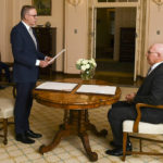 
              Anthony Albanese, second right, is sworn in as Australia's Prime Minister by Australian Governor-General David Hurley, right, during a ceremony at Government House in Canberra, Monday, May 23, 2022. Albanese has been sworn in ahead of a Tokyo summit while vote counting continues to decide whether he will control a majority in a Parliament that is demanding tougher action on climate change. (Lukas Coch/AAP Image via AP)
            