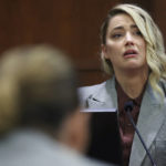 
              Actor Johnny Depp, left, listens as actor Amber Heard testifies in the courtroom in the Fairfax County Circuit Courthouse in Fairfax, Va., Thursday, May 26, 2022. Depp sued his ex-wife Heard for libel in Fairfax County Circuit Court after she wrote an op-ed piece in The Washington Post in 2018 referring to herself as a "public figure representing domestic abuse." (Michael Reynolds/Pool Photo via AP)
            