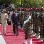 
              Former leader Mohamed Abdullahi Mohamed inspects a military honor guard during an official handover ceremony at the presidential palace in Mogadishu, Somalia, Monday, May 23, 2022. Hassan Sheikh Mohamud was elected to the nation's top office in a protracted contest decided by legislators on Sunday, May 15, 2022. (AP Photo/Farah Abdi Warsameh)
            