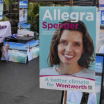 
              A volunteer stands amongst billboards for independent candidate Allegra Spender and incumbent Liberal candidate Dave Sharma outside a polling booth in Sydney, Australia on May 9, 2022. Sydney businesswoman Spender has an impeccable pedigree for a career in Australian politics. She is the daughter of a conservative federal lawmaker and granddaughter of a conservative cabinet minister. More surprising than her decision to run for office, she has chosen to become a candidate of a breakaway political grouping that has emerged as a threat to the ruling conservative Liberal Party.  (AP Photo/Mark Baker)
            