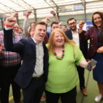 
              Naomi Long, centre, leader of the Alliance party celebrates with party members after there party success in the elections at the Medow Bank election count centre on Saturday, May, 7, 2022, in Magherafelt , Northern Ireland. (AP Photo/Peter Morrison)
            