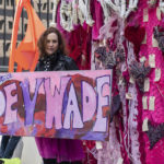 
              Artist Jacqueline Von Edelberg poses with an installation she created during an abortion-rights rally at Federal Plaza in the Loop, Saturday, May 7, 2022, in Chicago. (Pat Nabong/Sun-Times/Chicago Sun-Times via AP)
            
