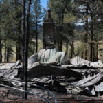 
              A burned building is seen in the Pendaries Village following a wildfire near Las Vegas, New Mexico, on Monday, May 2, 2022. Wind-whipped flames are marching across more of New Mexico's tinder-dry mountainsides, forcing the evacuation of area residents and dozens of patients from the state's psychiatric hospital as firefighters scramble to keep new wildfires from growing. The big blaze burning near the community of Las Vegas has charred more than 217 square miles. (AP Photo/Cedar Attanasio)
            