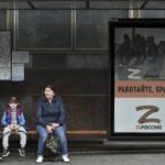 
              People sit at a bus stop decorated by a letter Z, which has become a symbol of the Russian military in Sevastopol, Crimea, Thursday, May 5, 2022.  (AP Photo)
            
