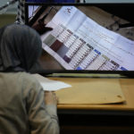 
              A candidate representative watches a screen displaying ballots after the close of a polling station at the end of the parliamentary election day, in Beirut, Lebanon, Sunday, May 15, 2022. Lebanese voted for a new parliament Sunday against the backdrop of an economic meltdown that is transforming the country and low expectations that the election would significantly alter the political landscape. (AP Photo/Hussein Malla)
            