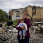 
              Nila Zelinska holds a doll belonging to her granddaughter, she was able to find in her destroyed house in Potashnya outskirts Kyiv, Ukraine, Tuesday, May 31, 2022. Zelinska just returned to her home town after escaping war to find out she is homeless. (AP Photo/Natacha Pisarenko)
            
