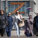 
              People walk past a letter Z, which has become a symbol of the Russian military, displayed on a building in St. Petersburg, Russia, Friday, May 6, 2022. (AP Photo/Dmitri Lovetsky)
            