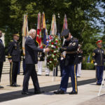 
              President Joe Biden lays a wreath at The Tomb of the Unknown Soldier at Arlington National Cemetery on Memorial Day, Monday, May 30, 2022, in Arlington, Va. Vice President Kamala Harris, left, and Defense Secretary Lloyd Austin, second from left, watch. (AP Photo/Andrew Harnik)
            