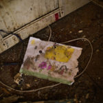 
              A child's drawing lays on the floor of Iryna Martsyniuk's home, heavily damaged after a Russian bombing in Velyka Kostromka village, Ukraine, Thursday, May 19, 2022. Martsyniuk and her three young children were at home when the attack occurred in the village, a few kilometres from the front lines, but they all survived unharmed. (AP Photo/Francisco Seco)
            