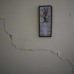 
              A crack runs through a wall alongside a painting hanging in Rev. David Gonzalez's apartment, located next to the Calvary Baptist Church building, damaged by an explosion that devastated the next door Hotel Saratoga in Old Havana, Cuba, Wednesday, May 11, 2022. Parts of the upper floors have collapsed at the building that houses not only the church but a seminary and the denomination's headquarters for western Cuba. (AP Photo/Ramon Espinosa)
            