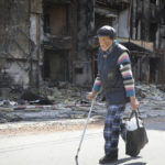 
              A resident walks past a destroyed house in Mariupol, in territory under the government of the Donetsk People's Republic, eastern Ukraine, Tuesday, May 17, 2022. (AP Photo/Alexei Alexandrov)
            