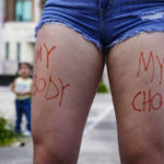 
              "My Body My Choice" is written in marker on Ada Sadlier's thighs Saturday, May 14, 2022, as part of the nationwide Bans Off Our Bodies Rally in Brownsville, Texas. The rally comes following a leaked draft opinion by Supreme Court Justice Samuel Alito last week, that suggests the conservative justices are prepared to overturn Roe v. Wade.  (Denise Cathey/The Brownsville Herald via AP)
            