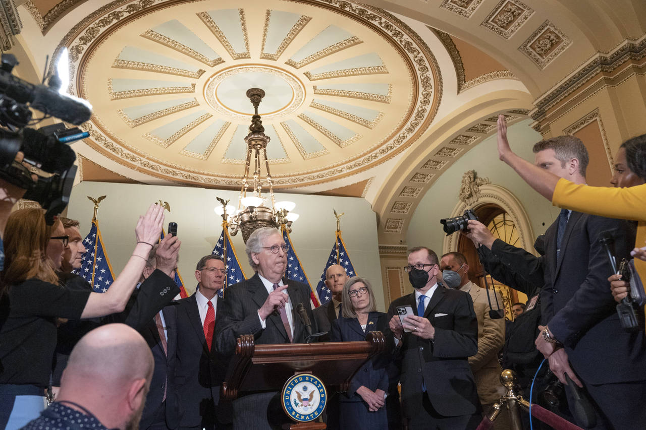 Senate Minority Leader Mitch McConnell of Ky., center, fields questions from reporters during a new...