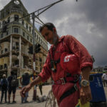 
              A member of the Cuban Red Cross takes a break after working in the rubble at the site of a deadly explosion that destroyed the five-star Hotel Saratoga in Old Havana, Cuba, Monday, May 9, 2022. (AP Photo/ Ramon Espinosa)
            