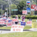 
              Campaign workers encourage votes for their local candidates near the Willowbrook Baptist Church polling station as Alabama votes in the state primary in Huntsville, Ala., Tuesday, May 24, 2022. (AP Photo/Vasha Hunt)
            