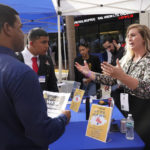 
              Brittany Dotson explains job opportunities at 0 Percent to job seekers at the Venture Miami Tech Hiring Fair Thursday, April 14, 2022, in Miami.  America’s employers added 428,000 jobs in April, extending a streak of solid hiring that has defied punishing inflation, chronic supply shortages, the Russian war against Ukraine and much higher borrowing costs.  (AP Photo/Marta Lavandier)
            