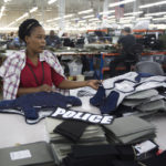 
              FILE - Laurette Eugene assembles a body armor vest at the Point Blank Body Armor factory in Pompano Beach, Fla., Sept. 19, 2014. When a shooter attacked a supermarket in Buffalo, New York,May 14, 2022, its security guard tried to stop him. At least one of the guard's shots hit the gunman, but it didn’t stop the deadly rampage because the gunman was wearing body armor. (AP Photo/J Pat Carter, File)
            