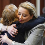 
              Actor Amber Heard hugs her attorney Elaine Bredehoft after closing arguments at the Fairfax County Circuit Courthouse in Fairfax, Va., Friday, May 27, 2022. Actor Johnny Depp sued his ex-wife Amber Heard for libel in Fairfax County Circuit Court after she wrote an op-ed piece in The Washington Post in 2018 referring to herself as a "public figure representing domestic abuse." (AP Photo/Steve Helber, Pool)
            