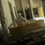 
              FILE - A worker, wearing full protective gear, moves the casket of a victim of COVID-19 to be cremated during a partial lockdown to prevent the spread of coronavirus at the Pontes crematorium center in Lommel, Belgium, Thursday, April 16, 2020. The World Health Organization is estimating that nearly 15 million people were killed either by the coronavirus or by its impact on overwhelmed health systems in the past two years. That is more than double its official death toll. The U.N. health agency says most of the fatalities were in Southeast Asia, Europe and the Americas. In a report released Thursday, May 5, 2022 WHO chief Tedros Adhanom Ghebreyesus describes the figure as “sobering."  (AP Photo/Francisco Seco, File)
            