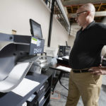 
              Mercer County Director of Elections, Thad Hall uses the optical scanner to continue counting ballots for the Pennsylvania primary election, Wednesday, May 18, 2022, in Mercer, Pa.. Vote counting continues as Republican candidates Dr. Mehmet Oz and David McCormick are locked in a too-early-to-call race for Pennsylvania's hotly contested Republican nomination for an open U.S. Senate seat. (AP Photo/Keith Srakocic)
            