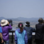 
              Visitors use binoculars to see the North Korean side from the unification observatory in Paju, South Korea, Thursday, May 12, 2022. North Korea imposed a nationwide lockdown Thursday to control its first acknowledged COVID-19 outbreak after holding for more than two years to a widely doubted claim of a perfect record keeping out the virus that has spread to nearly every place in the world. (AP Photo/Lee Jin-man)
            