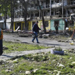 
              A man walks past an apartment building destroyed by night shelling in Kramatorsk, Ukraine, Thursday, May 5, 2022. (AP Photo/Andriy Andriyenko)
            