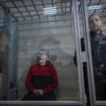 
              Russian soldiers Alexander Alexeevich Ivanov, right, and Alexander Vladimirovich Bobykin attend their trial hearing in Kotelva, northeastern Ukraine, Thursday, May 26, 2022. Two Russian soldiers accused of war crime in Ukraine could face up to 12 years in prison. In the second hearing of the trial held on Thursday at the Kotelevsky District Court, the prosecutors asked for both to be sentenced to 12 years of prison, while the defence attorney asked for 8 years. (AP Photo/Bernat Armangue)
            