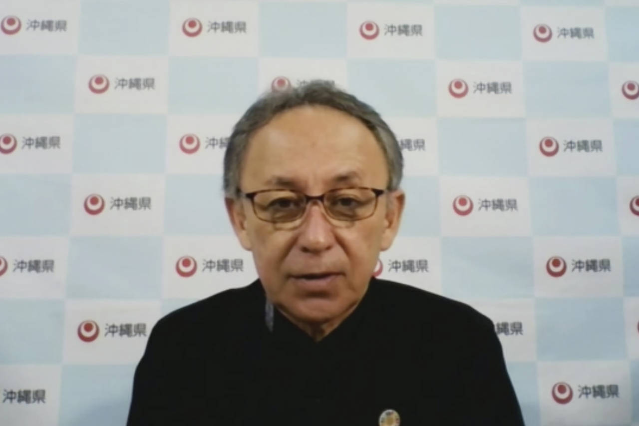 In this image made from video, Japan's southern island of Okinawa Gov. Denny Tamaki speaks online F...