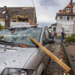 
              A damaged car is seen after a storm in Paderborn, Germany, Friday, May 20, 2022. (Lino Mirgeler/dpa via AP)
            