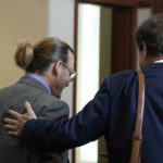 
              Attorney Ben Chew leaves with his client, actor Johnny Depp at the Fairfax County Circuit Court in Fairfax, Va., Wednesday May 4, 2022. Depp sued his ex-wife actor Amber Heard for libel in Fairfax County Circuit Court after she wrote an op-ed piece in The Washington Post in 2018 referring to herself as a "public figure representing domestic abuse." (Elizabeth Frantz/Pool Photo via AP)
            