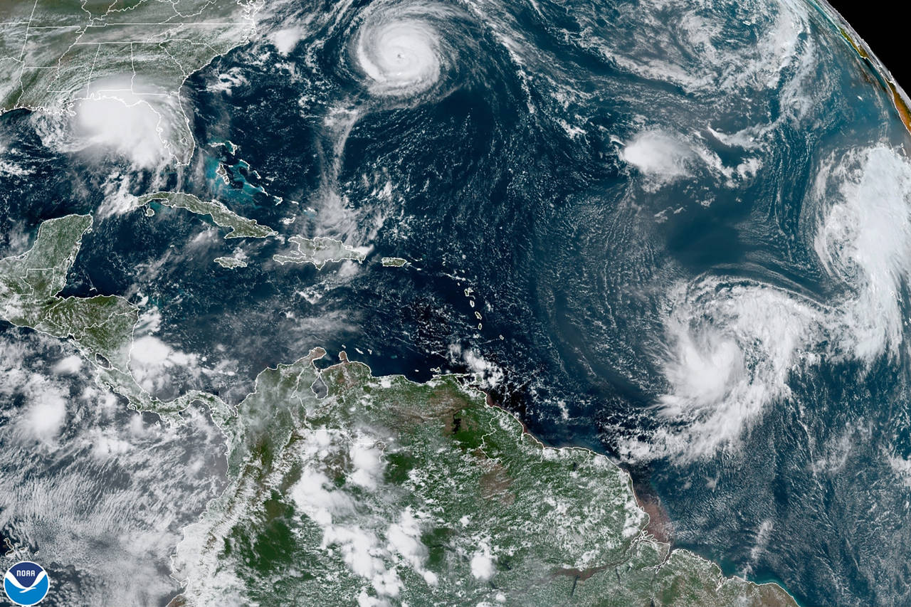 FILE - This satellite image provided by the NOAA shows five tropical storms churning in the Atlanti...