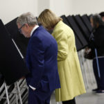 
              Ohio Gov. Mike DeWine, left, casts his primary vote next to Ohio first lady Fran DeWine at their polling place in Cedarville, Ohio, Tuesday, May 3, 2022. (AP Photo/Paul Vernon)
            