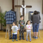 
              From let,  Matthew Reeder, Thomas Reeder and Ruth Reeder wait for their parents Keith Reeder and Chani Reeder to cast their ballots in Idaho's Primary Election, Tuesday, May 17, 2022, in Emmett, Idaho. (AP Photo/Kyle Green)
            