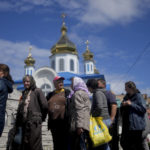 
              People line up outside a Church to get food and clothing in Borodyanka, on the outskirts of Kyiv, Ukraine, Tuesday, May 31, 2022. (AP Photo/Natacha Pisarenko)
            