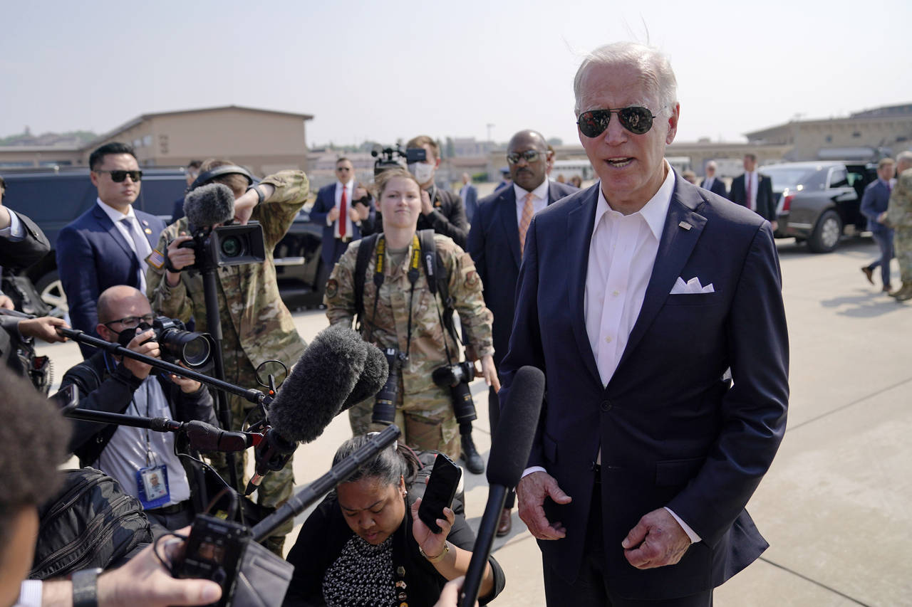 U.S. President Joe Biden speaks before boarding Air Force One for a trip to Japan at Osan Air Base,...