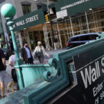 
              FILE - People walk on Broadway at Wall Street, Wednesday, June 16, 2021.  Stocks are opening lower on Wall Street, Wednesday, May 18, 2022, led by steep drops in retailers as Target plunged after issuing a grim quarterly earnings report.AP Photo/Richard Drew, File)
            