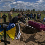 
              Relatives and friends attend the funeral of Ukrainian serviceman Vitaliy Nejenits in Kharkiv cemetery, eastern Ukraine, Friday, May 27, 2022. (AP Photo/Bernat Armangue)
            