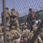 
              FILE - This image from a video released by the Department of Defense shows U.S. Marines at Abbey Gate before a suicide bomber struck outside Hamid Karzai International Airport on Aug. 26, 2021, in Kabul Afghanistan. A new report says decisions by Presidents Donald Trump and Joe Biden to pull all U.S. troops out of Afghanistan were the key factors in the collapse of that nation's military, leading to the Taliban takeover last year. (Department of Defense via AP, File)
            