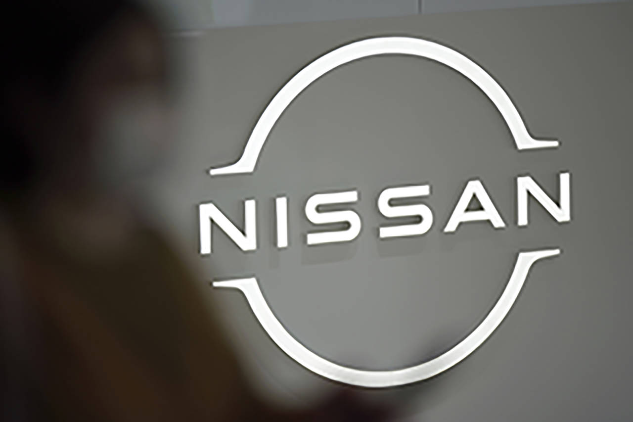 FILE - A visitor walks near a Nissan logo at Nissan headquarters on May 12, 2022, in Yokohama near ...