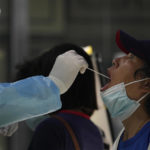 
              A resident gets swabbed during mass COVID test on Monday, May 23, 2022, in Beijing. (AP Photo/Ng Han Guan)
            