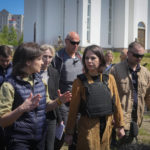 
              German Foreign Minister Annalena Baerbock, center, and Ukrainian Prosecutor General Iryna Venediktova talk as they stand near a mass grave in Bucha, on the outskirts of Kyiv, Ukraine, Tuesday, May 10, 2022. (AP Photo/Efrem Lukatsky)
            