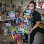 
              Gabriella Duran helps at the Mora Head Start building sort through food donated to families choosing to remain in Mora, N.M., on Wednesday, May 4, 2022. Weather conditions described as potentially historic are on tap for New Mexico on Saturday, May 7, and over the next several days as the largest fire burning in the U.S. chews through more tinder-dry mountainsides. (Jim Weber/Santa Fe New Mexican via AP)
            