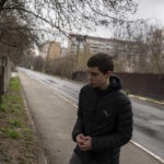 
              Yura Nechyporenko, 15, stands at the scene were his father was executed, in Bucha, on the outskirts of Kyiv, Ukraine, on Thursday, April 21, 2022. The teen survived an execution attempt by Russian soldiers while his father was killed, and now his family seeks justice. (AP Photo/Petros Giannakouris)
            