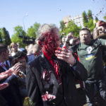 
              Russian Ambassador to Poland, Ambassador Sergey Andreev is covered with red paint in Warsaw, Poland, Monday, May 9, 2022. Protesters have thrown red paint on the Russian ambassador as he arrived at a cemetery in Warsaw to pay respects to Red Army soldiers who died during World War II. Ambassador Sergey Andreev arrived at the Soviet soldiers cemetery on Monday to lay flowers where a group of activists opposed to Russia’s war in Ukraine were waiting for him. (AP Photo/Maciek Luczniewski)
            