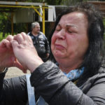 
              A woman reacts during an evacuation of civilians in Soledar, Donetsk region, Ukraine, Tuesday, May 24, 2022. (AP Photo/Andriy Andriyenko)
            